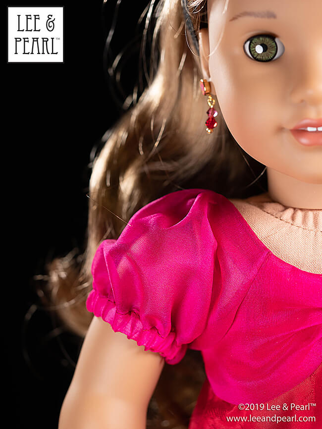 We made our American Girl doll’s jewel-toned dress using silk organza and figured China silk from our COMING SOON silk fabric kits, and Lee & Pearl Pattern 1038: The Gift Bow Front Dress for 18 Inch, 16 Inch and 14 1/2 Inch Dolls. This pattern is our FREE gift to Lee & Pearl mailing list subscribers in 2019. Get your own copy of this lovely pattern — sign up today!
