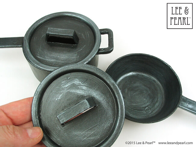 Give 18 inch doll-sized plastic Dollar Store toy pans a "cast iron" finish with this fun painting tutorial from Lee & Pearl.