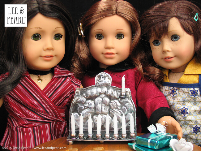 Happy Chanukah from Lee & Pearl! Make your 18 inch dolls their very own pressed metal Chanukah Menorah (Chanukiya) using a dollar store cookie sheet, cardboard, glue, plastic beads, a knitting needle, metallic paints and the techniques in our easy VIDEO TUTORIAL.